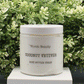 Jar of 'Coconut Vetiver' body butter cream with 'Birch Beauty' branding on a light surface with greenery in the background. Handmade in Rhode Island. Made with limited ingredients.